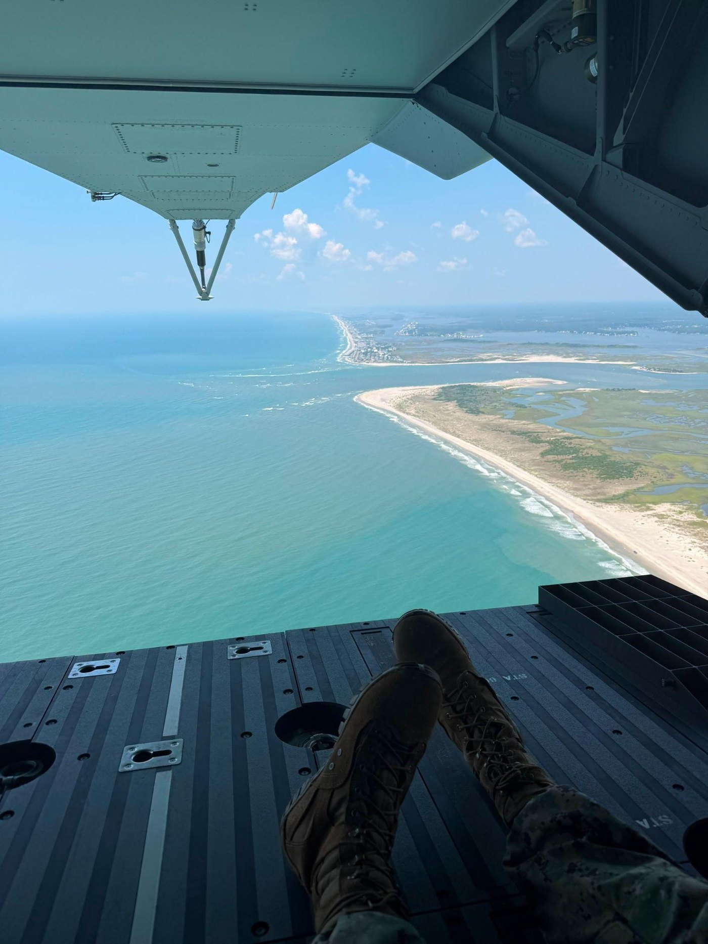 Midshipmen view the coastline from a Marine Corps transport aircraft during MAGTF