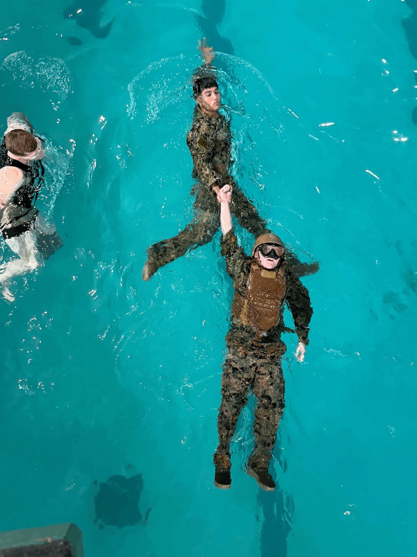 Midshipmen train on towing a casualty in full gear during MCIWS