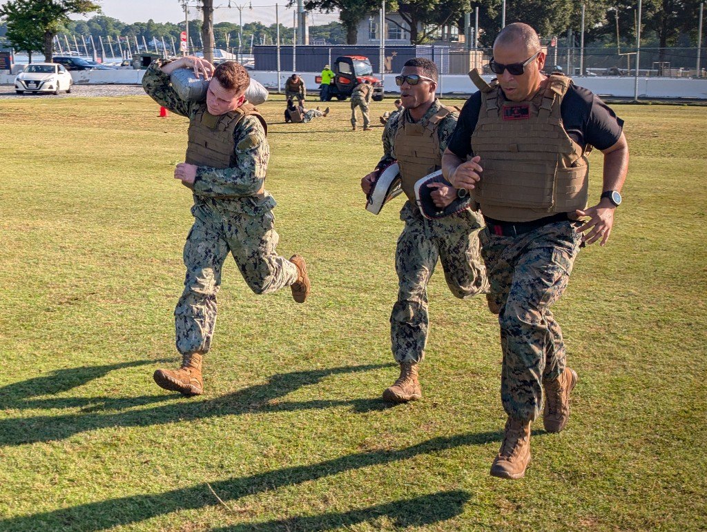 Midshipmen train with sandbags and focus mitts during an MCMAP conditioning evolution
