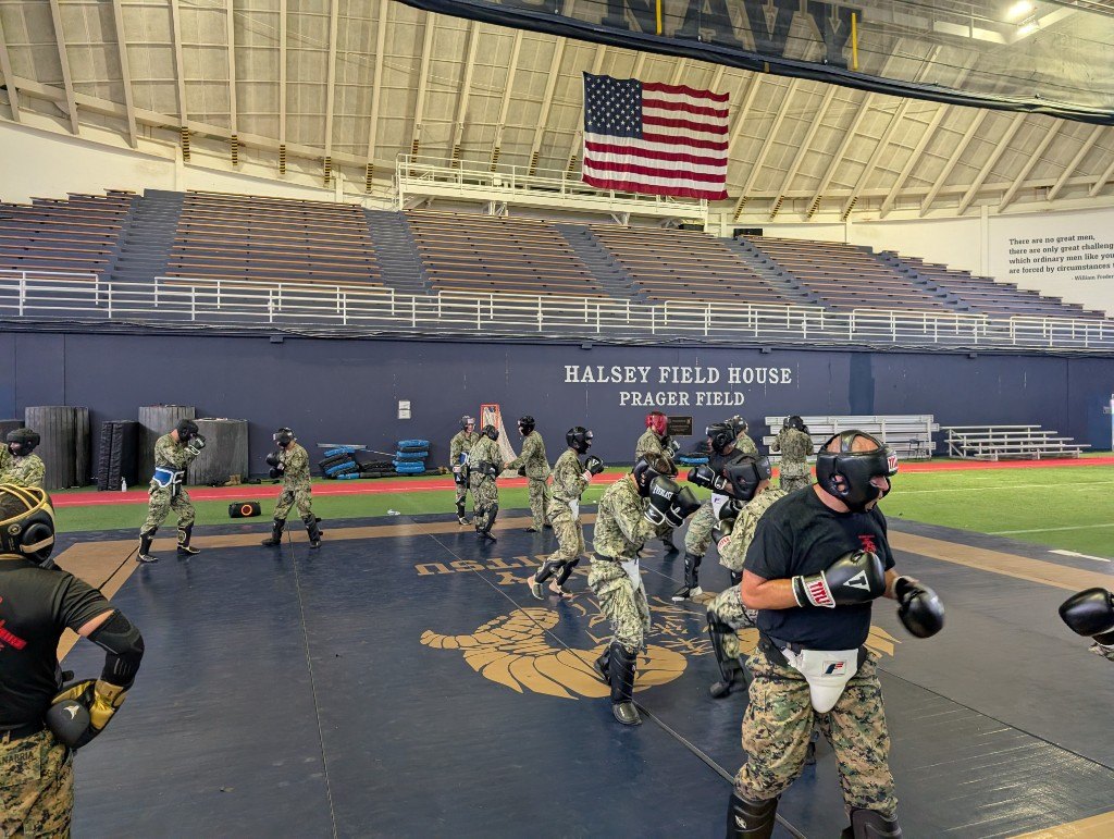 Midshipmen spar in full MCMAP protective gear at Halsey Field House