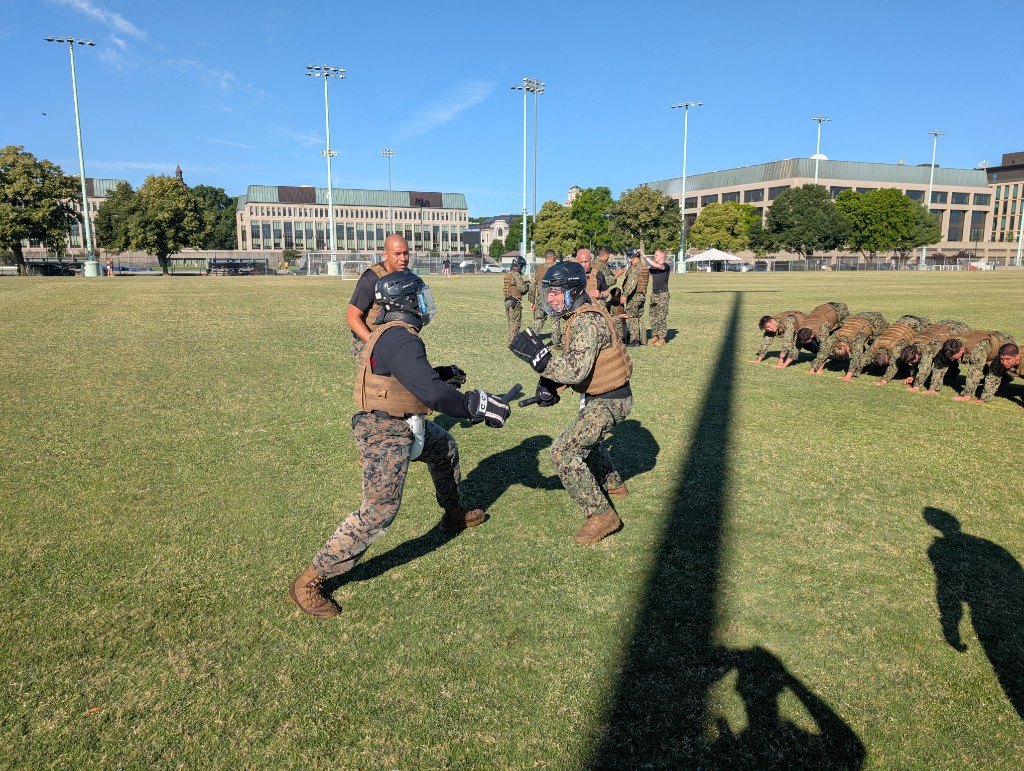 Marines and midshipmen conduct padded baton drills during MAI training