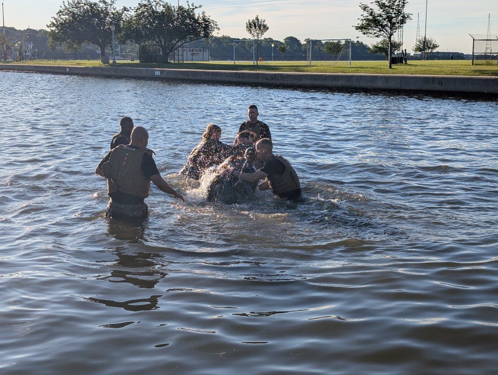 Midshipmen practice grappling during MCMAP training in the water