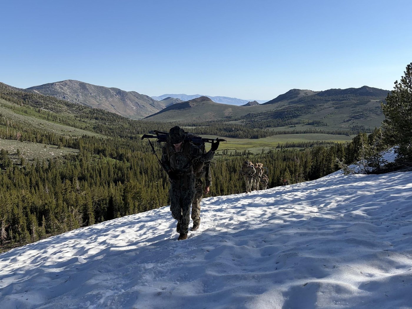 Midshipmen move through snow-covered alpine terrain during MWTC